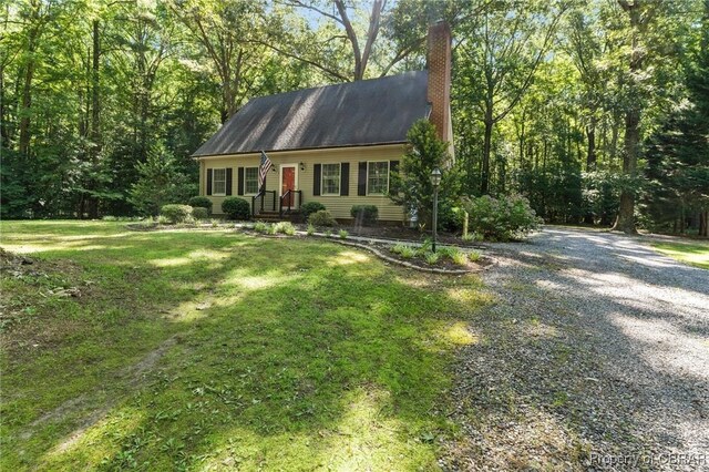 542 Cod Creek Dr, Heathsville, VA 22473 - cape cod house featuring a chimney, a front lawn, and driveway