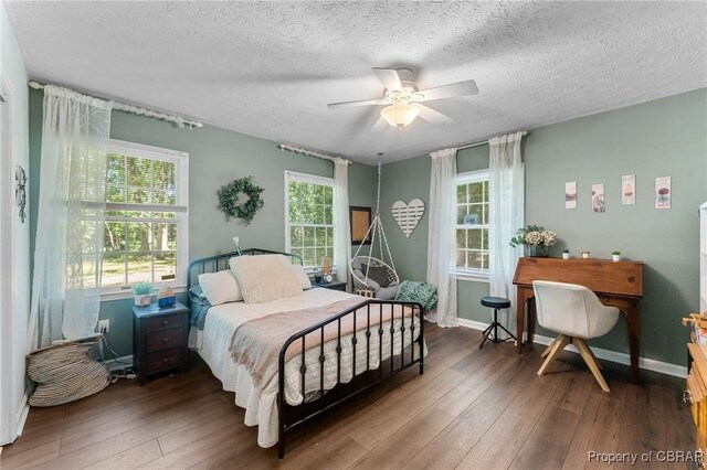 542 Cod Creek Dr, Heathsville, VA 22473 - bedroom with hardwood / wood-style floors, a textured ceiling, a ceiling fan, and baseboards