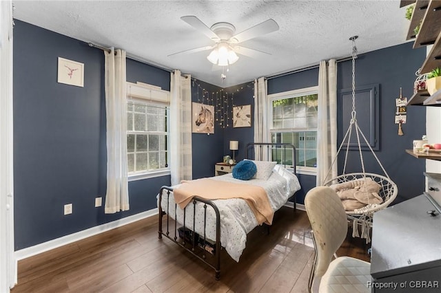 542 Cod Creek Dr, Heathsville, VA 22473 - bedroom with wood-type flooring, baseboards, a textured ceiling, and a ceiling fan