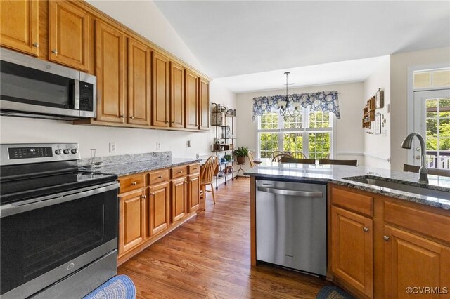 1629 Olmstead Dr, Powhatan, VA 23139 - kitchen with stainless steel appliances, a sink, a chandelier, and dark wood-type flooring