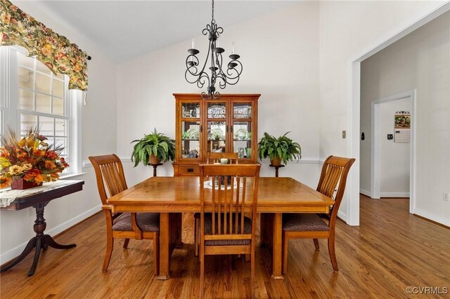 1629 Olmstead Dr, Powhatan, VA 23139 - dining area with wood finished floors, a chandelier, baseboards, and high vaulted ceiling