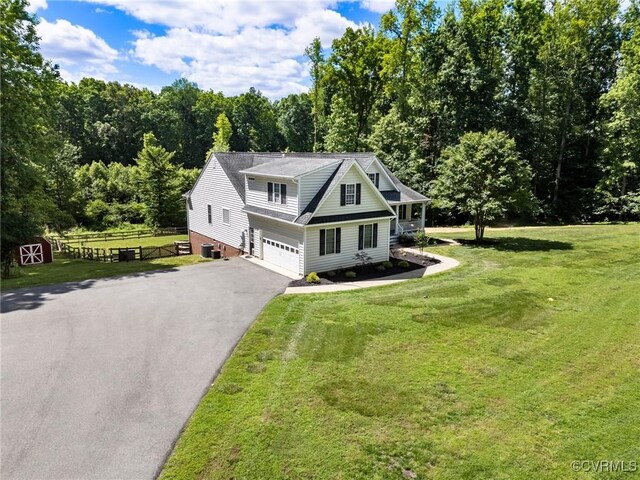1629 Olmstead Dr, Powhatan, VA 23139 - view of front of house featuring driveway, an attached garage, and a forest view