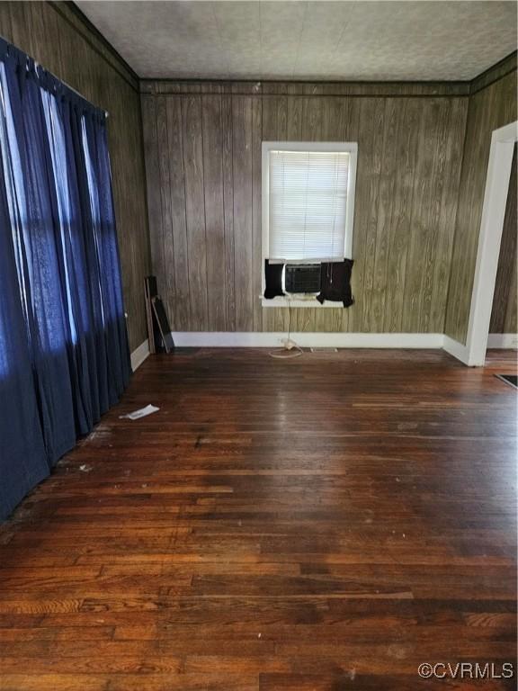 302 N High St, Blackstone, VA 23824 - unfurnished room featuring cooling unit, wood finished floors, and wood walls