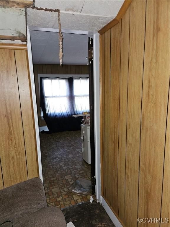 302 N High St, Blackstone, VA 23824 - hall featuring wooden walls and brick patterned flooring