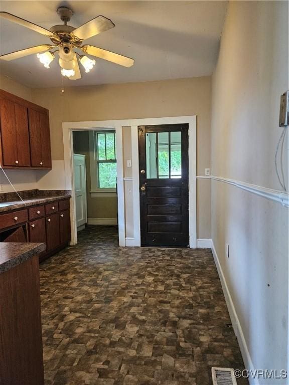 302 N High St, Blackstone, VA 23824 - kitchen with dark countertops, dark stone finish flooring, and ceiling fan