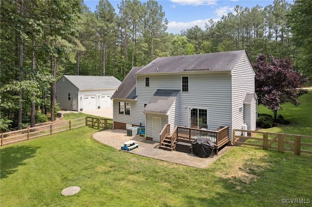 2554 Walkers Ridge Ter, Powhatan, VA 23139 - rear view of house featuring a wooden deck, an outbuilding, a garage, roof with shingles, and central AC