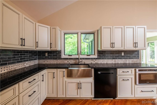 1396 Gray Fox Rd, Goochland, VA 23103 - kitchen with black dishwasher, stainless steel oven, a sink, dark countertops, and lofted ceiling