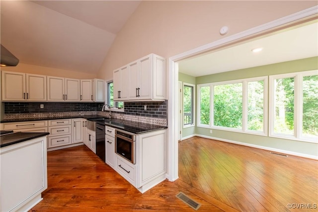 1396 Gray Fox Rd, Goochland, VA 23103 - kitchen with tasteful backsplash, black dishwasher, white cabinets, hardwood / wood-style floors, and vaulted ceiling