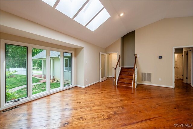 1396 Gray Fox Rd, Goochland, VA 23103 - unfurnished living room with a skylight, lofted ceiling, baseboards, wood finished floors, and stairway