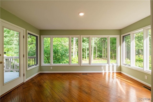 1396 Gray Fox Rd, Goochland, VA 23103 - unfurnished sunroom with baseboards and wood-type flooring