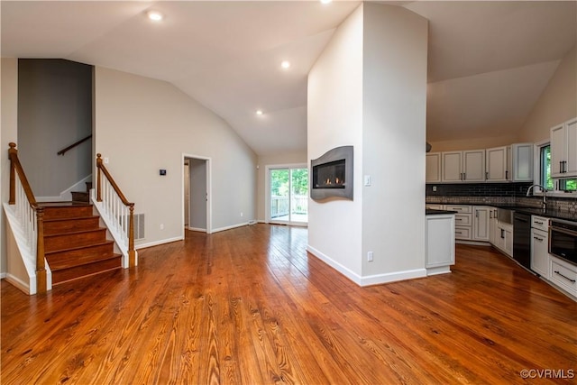 1396 Gray Fox Rd, Goochland, VA 23103 - kitchen featuring vaulted ceiling, black dishwasher, dark countertops, open floor plan, and tasteful backsplash