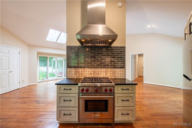 1396 Gray Fox Rd, Goochland, VA 23103 - kitchen featuring wall chimney exhaust hood, designer range, vaulted ceiling, a skylight, and dark countertops