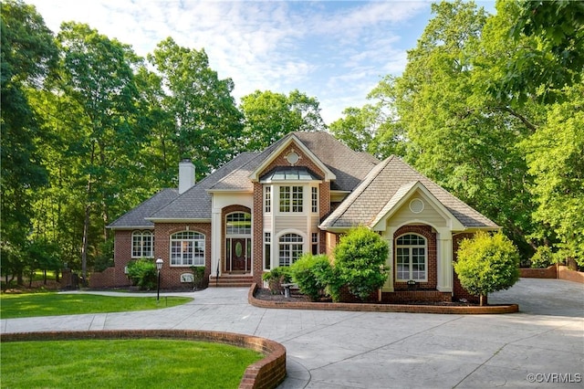 8831 Whistling Swan Rd, Chesterfield, VA 23838 - view of front of property featuring brick siding, a chimney, and a front lawn