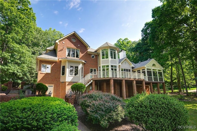 8831 Whistling Swan Rd, Chesterfield, VA 23838 - rear view of house with a sunroom, stairway, brick siding, and a wooden deck
