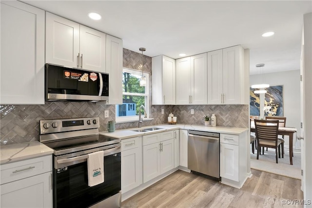 11202 Heathstead Rd, Chester, VA 23831 - kitchen with stainless steel appliances, a sink, white cabinetry, hanging light fixtures, and recessed lighting