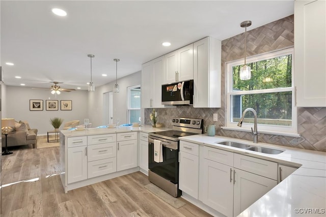 11202 Heathstead Rd, Chester, VA 23831 - kitchen featuring appliances with stainless steel finishes, a sink, open floor plan, a peninsula, and white cabinetry