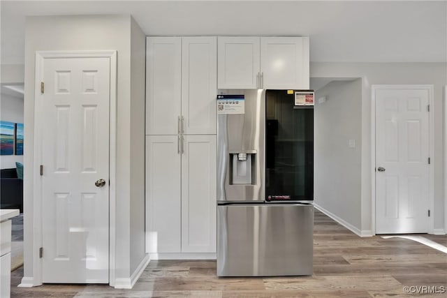 11202 Heathstead Rd, Chester, VA 23831 - kitchen with stainless steel refrigerator with ice dispenser, white cabinets, baseboards, and light wood-type flooring