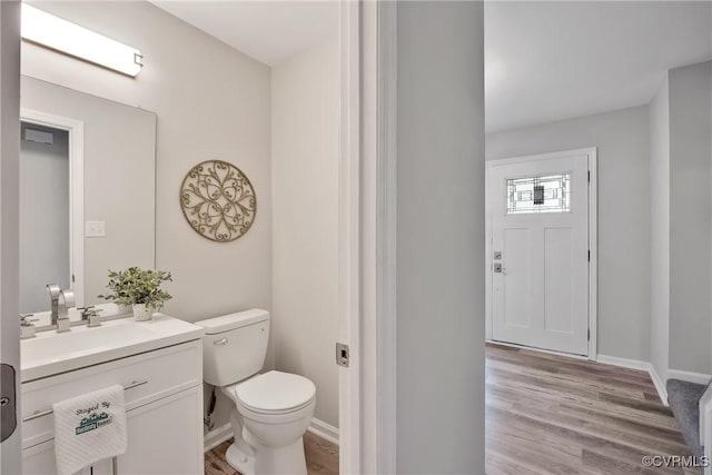11202 Heathstead Rd, Chester, VA 23831 - bathroom with vanity, toilet, wood finished floors, and baseboards