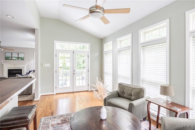 12109 Jamieson Pl, Henrico, VA 23059 - living area with ceiling fan, light wood-style floors, lofted ceiling, a glass covered fireplace, and french doors