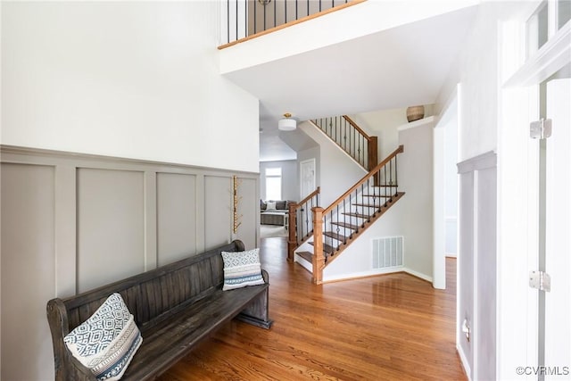 12109 Jamieson Pl, Henrico, VA 23059 - living area with a decorative wall, wood finished floors, stairway, and wainscoting