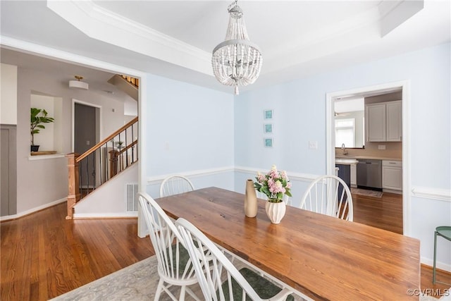 12109 Jamieson Pl, Henrico, VA 23059 - dining area featuring a chandelier, wood finished floors, a raised ceiling, and crown molding