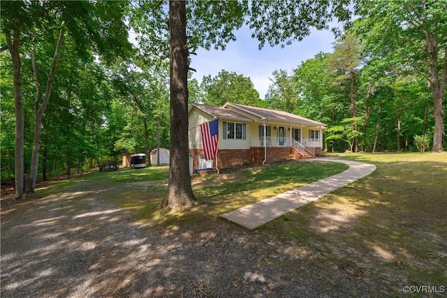 17063 Moores Mill Rd, Ruther Glen, VA 22546 - ranch-style house featuring covered porch and a front lawn