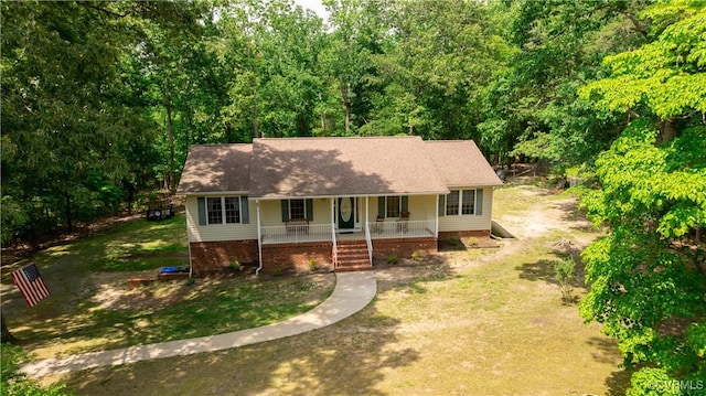 17063 Moores Mill Rd, Ruther Glen, VA 22546 - view of front facade with a porch, a front yard, and a shingled roof