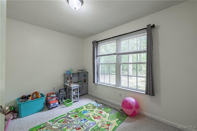 17063 Moores Mill Rd, Ruther Glen, VA 22546 - recreation room featuring carpet flooring, baseboards, and a textured ceiling