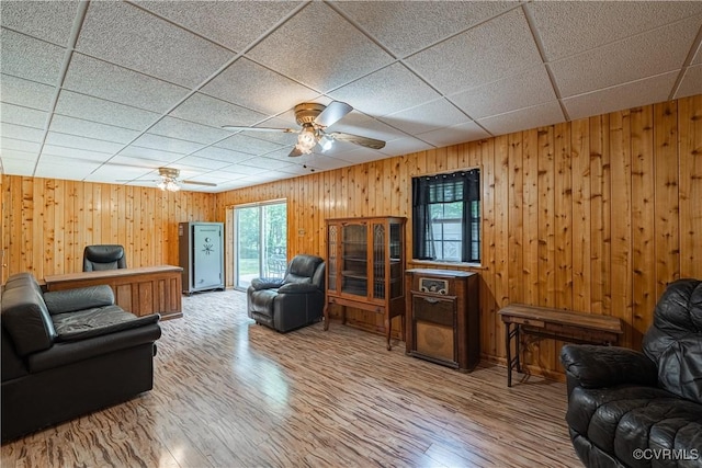 17063 Moores Mill Rd, Ruther Glen, VA 22546 - living room featuring a ceiling fan, wood finished floors, a drop ceiling, and wood walls