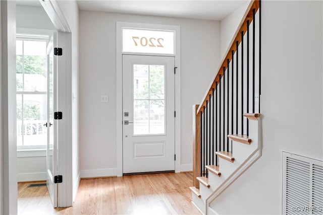 2207 Fairmount Ave, Richmond, VA 23223 - foyer with stairs, healthy amount of natural light, and light wood-style floors
