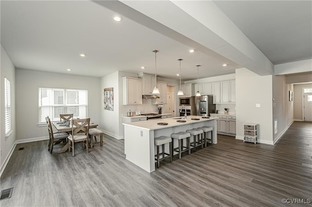 18160 Sagamore Dr, Chesterfield, VA 23120 - kitchen with stainless steel appliances, baseboards, healthy amount of natural light, a kitchen bar, and recessed lighting