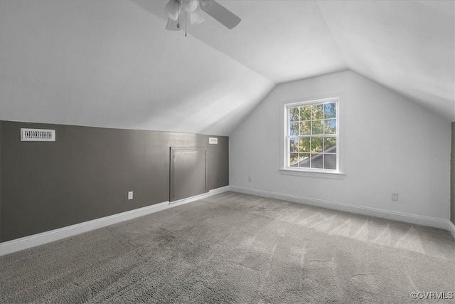 additional living space with carpet floors, a ceiling fan, lofted ceiling, and baseboards