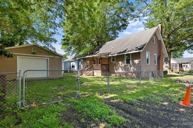 view of front of house with an outbuilding, a detached garage, and a gate