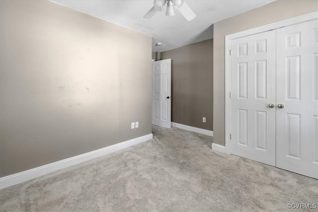 unfurnished bedroom with carpet, baseboards, a closet, and ceiling fan