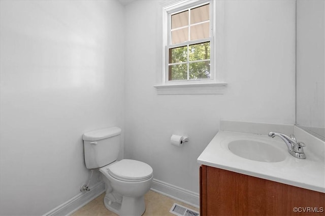 bathroom with baseboards, toilet, and vanity