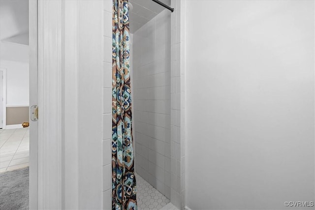 bathroom featuring a stall shower, tile patterned floors, and baseboards