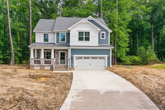 107 Wheeley Cir, Yorktown, VA 23693 - view of front of house with covered porch, a standing seam roof, a garage, and driveway