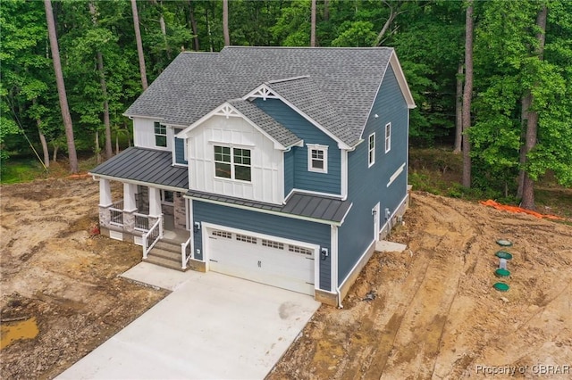 107 Wheeley Cir, Yorktown, VA 23693 - view of front of home featuring a shingled roof, a standing seam roof, a porch, and an attached garage