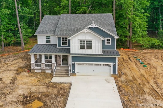 107 Wheeley Cir, Yorktown, VA 23693 - view of front of property featuring board and batten siding, covered porch, roof with shingles, a garage, and driveway