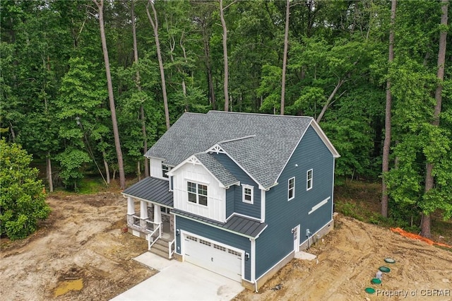 107 Wheeley Cir, Yorktown, VA 23693 - view of front of house featuring a standing seam roof, board and batten siding, metal roof, an attached garage, and a shingled roof