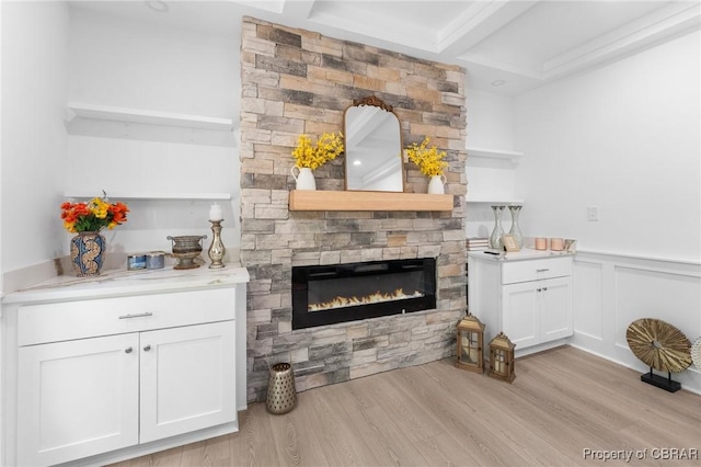 107 Wheeley Cir, Yorktown, VA 23693 - living room featuring a fireplace, light wood finished floors, beam ceiling, a wainscoted wall, and a decorative wall