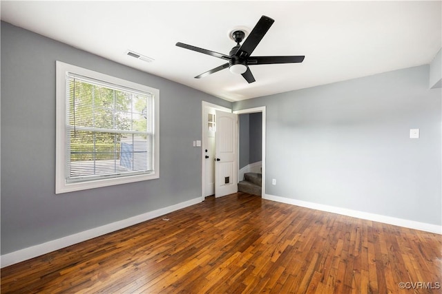 317 Cedar Ln, Hopewell, VA 23860 - unfurnished room with baseboards, wood-type flooring, a ceiling fan, and stairway