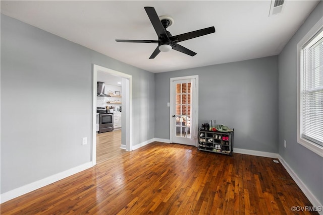 317 Cedar Ln, Hopewell, VA 23860 - empty room featuring ceiling fan, wood finished floors, baseboards, and plenty of natural light