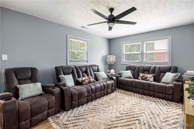 317 Cedar Ln, Hopewell, VA 23860 - living room with wood finished floors, ceiling fan, and a textured ceiling