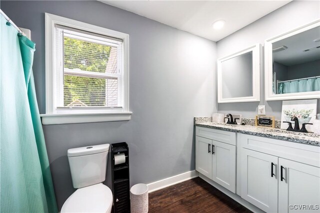 317 Cedar Ln, Hopewell, VA 23860 - bathroom with wood finished floors, baseboards, toilet, and double vanity