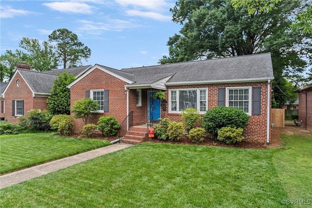 4719 W Grace St, Richmond, VA 23230 - view of front of home featuring brick siding, a front yard, and a shingled roof