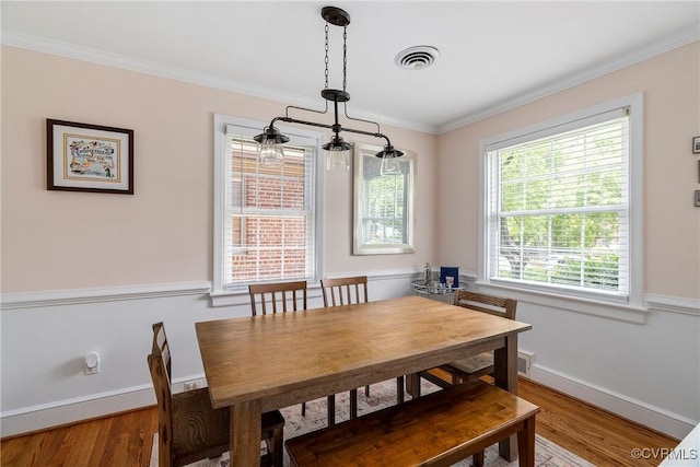 4719 W Grace St, Richmond, VA 23230 - dining space with wood finished floors, baseboards, and ornamental molding