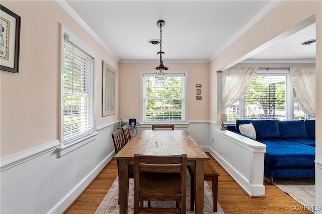4719 W Grace St, Richmond, VA 23230 - dining room featuring wood finished floors, baseboards, and crown molding