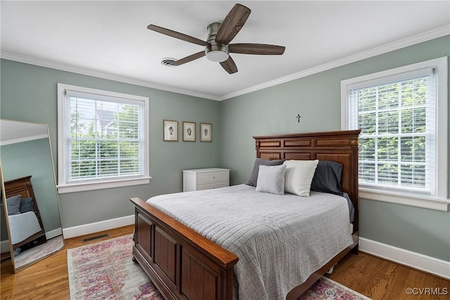 4719 W Grace St, Richmond, VA 23230 - bedroom featuring multiple windows, ornamental molding, baseboards, light wood-type flooring, and a ceiling fan