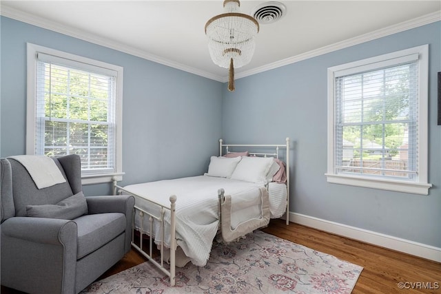 4719 W Grace St, Richmond, VA 23230 - bedroom featuring a chandelier, wood finished floors, crown molding, and baseboards